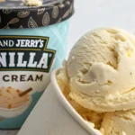 Scooped vanilla ice cream in a container beside a Ben & Jerry’s label, inspired by the Ben and Jerry’s Vanilla Ice Cream Recipe.