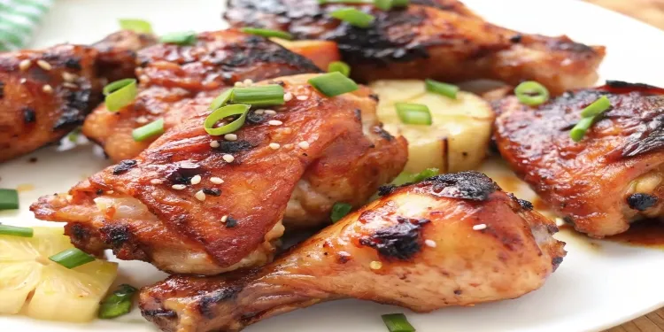 Huli Huli Chicken served on a plate with grilled pineapple and rice