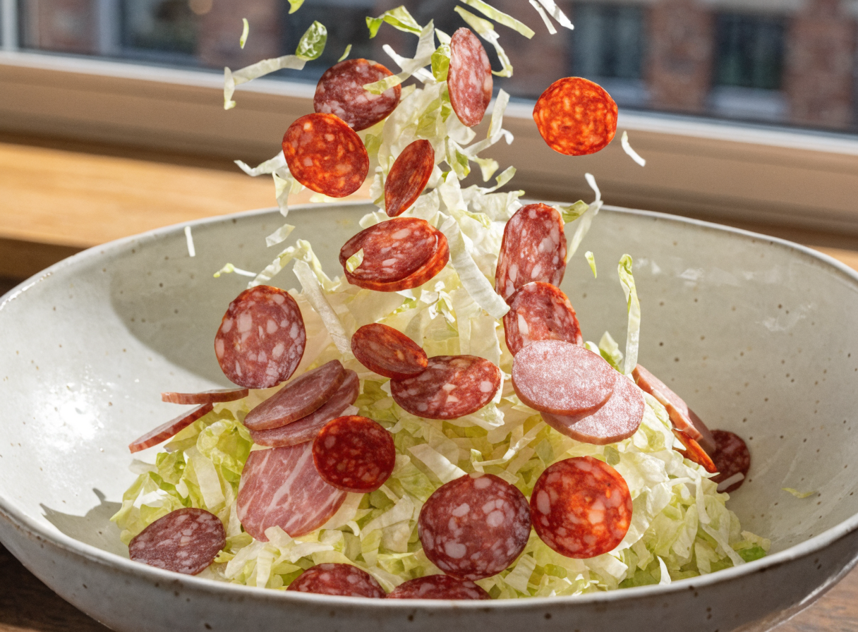 What is in an Italian grinder salad bowl? step 1 - A close-up photograph of thinly sliced s