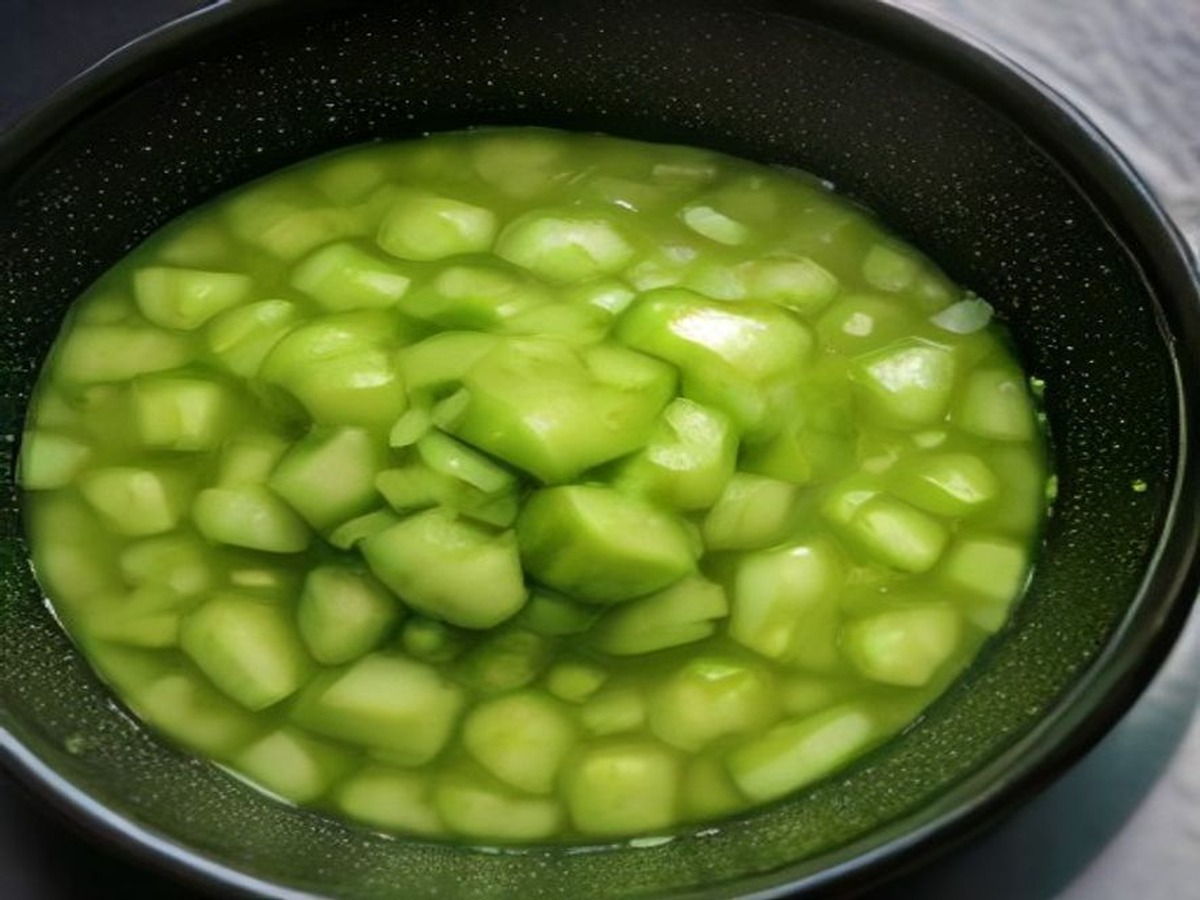 Why do you smash cucumbers in a salad? cooking technique - A detailed top-down photograph of crushed cucumber chunks absorbing a